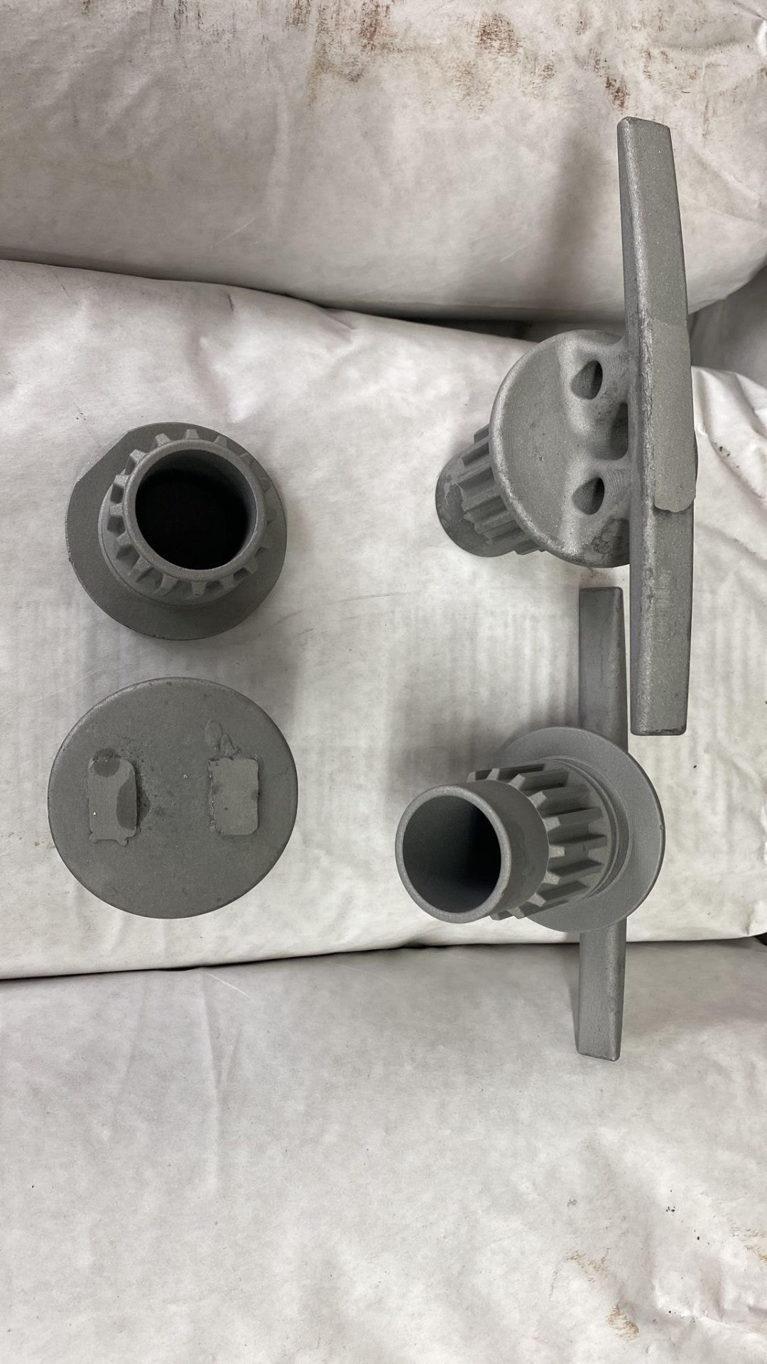 Raw stainless steel castings of the cleat and stopper cap