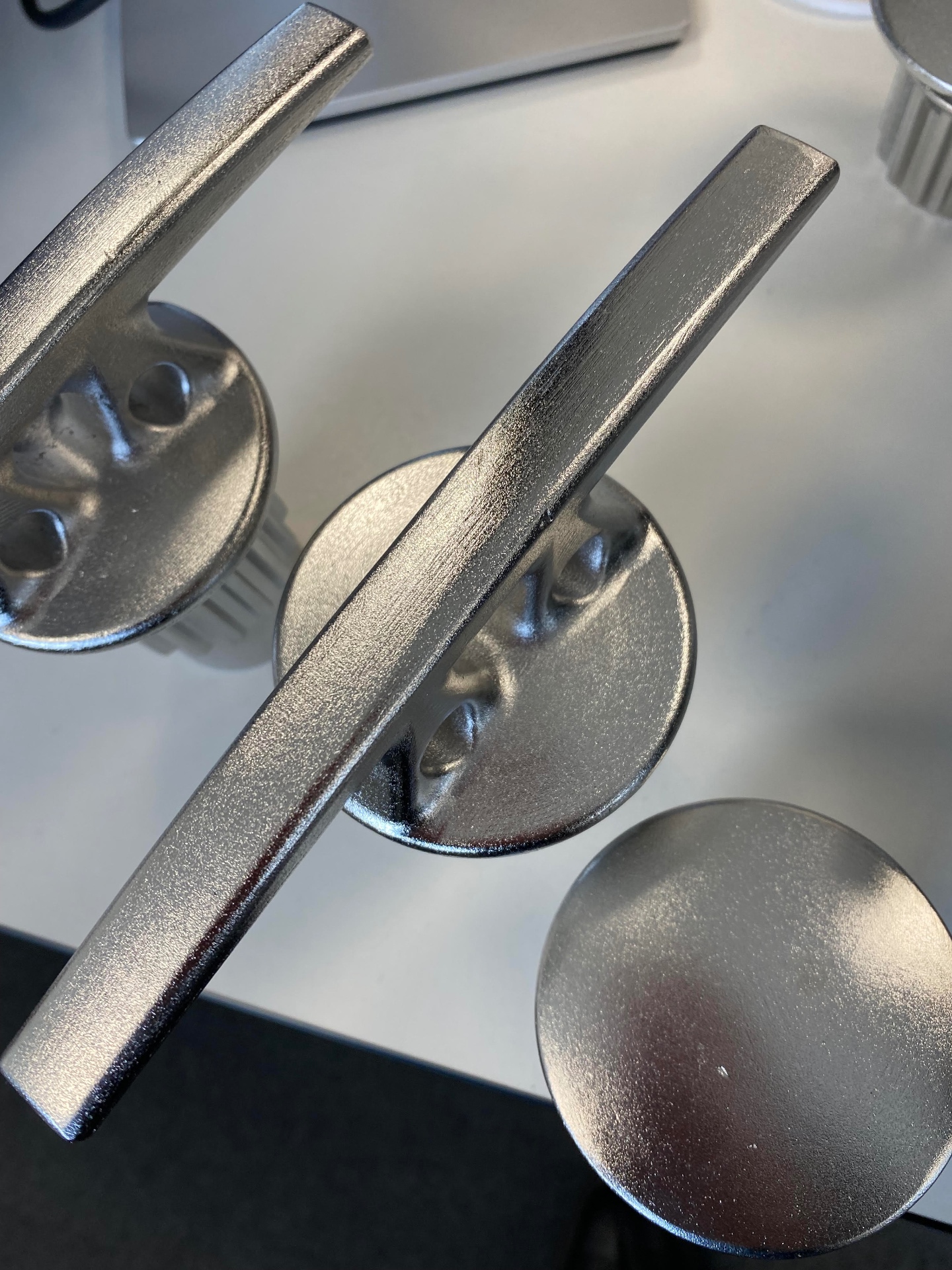 Finished stainless steel cleats and stopper caps